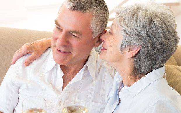 Senior couple relaxing together with wine
