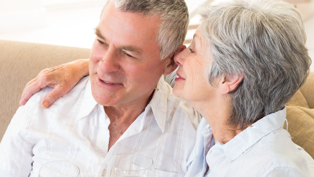 Senior couple relaxing together with wine