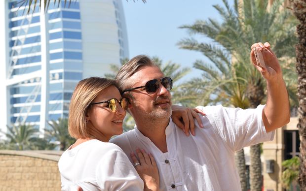 Happy mature couple taking a selfie while traveling