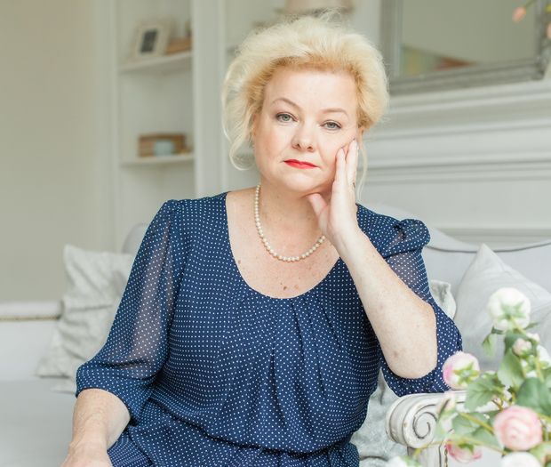 Elegant senior woman relaxing at home with a warm smile