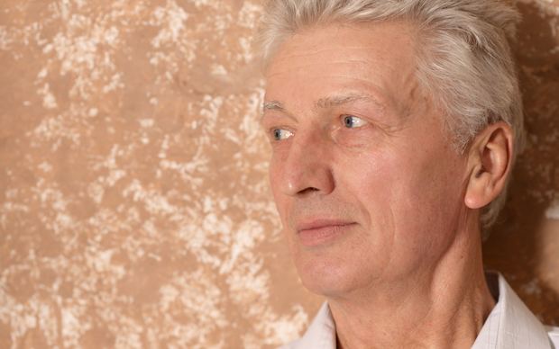Senior man smiling confidently outdoors